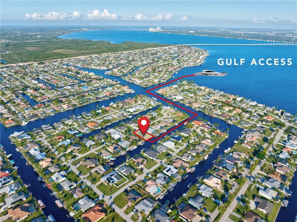 Image 1: Waterfront community with extensive canal system, direct Gulf access, residential properties, and surrounding natural landscapes