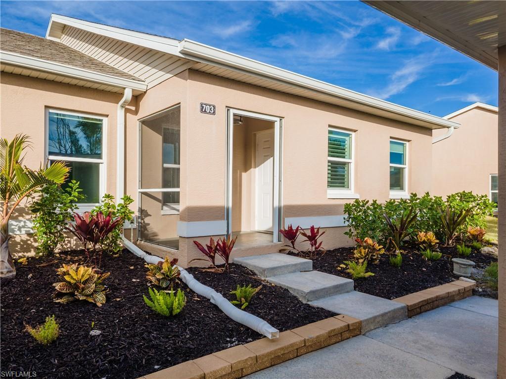 Image 3: View of exterior entry featuring stucco siding