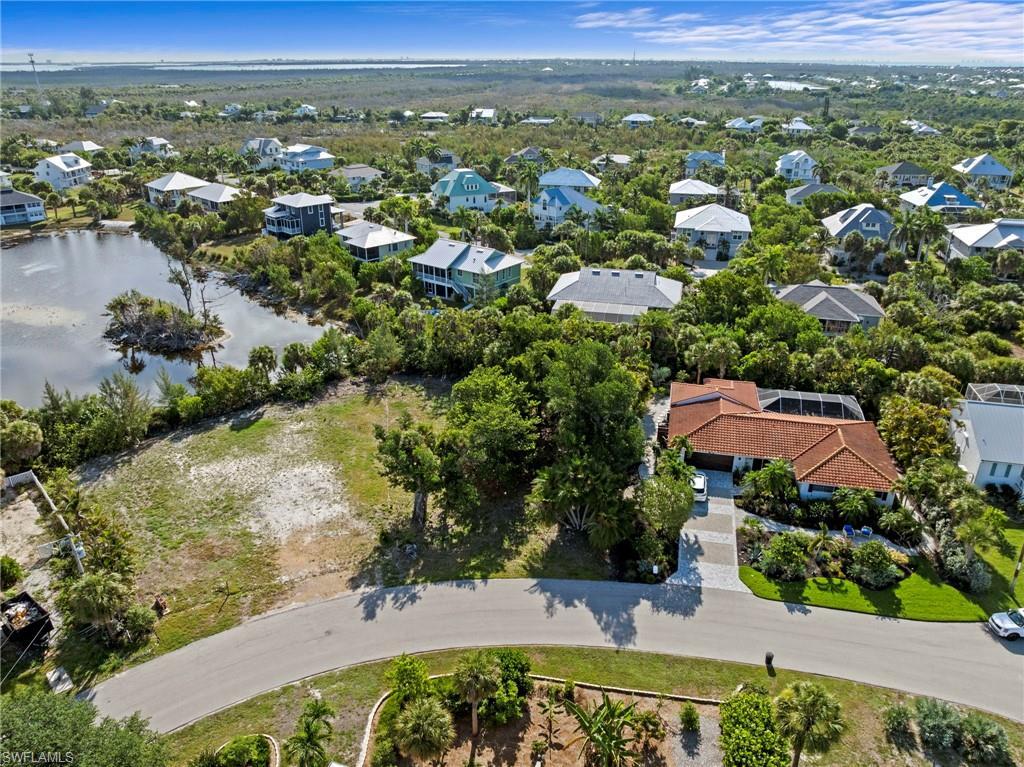 Image 4: Aerial depiction of a residential property featuring a terracotta-tiled roof and a screened-in pool enclosure