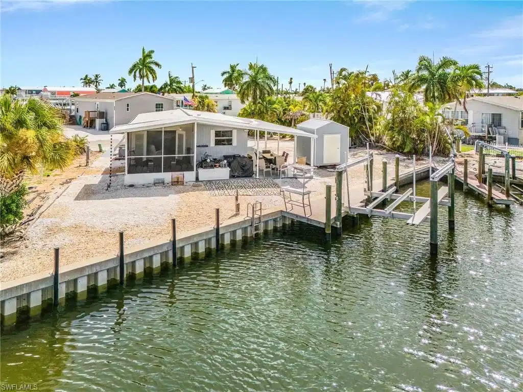 Image 1: Rear of the home with RV Hookup on the east side and plenty of room for Two boats!!