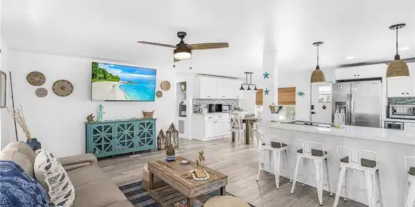 Image 4: Open concept living area featuring wood-finish flooring, a ceiling fan, and recessed lighting
