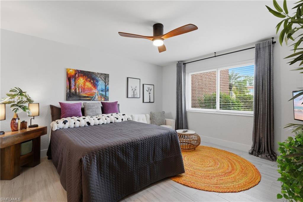 Image 3: Light-toned wood-finish flooring provides a neutral backdrop for a large window featuring horizontal blinds
