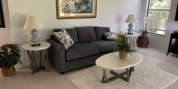 Image 2: Living area featuring light tile patterned floors and baseboards