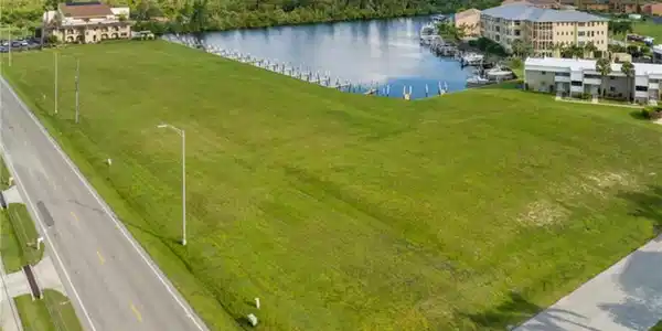 Image 3: Aerial view featuring level lot with water view and access