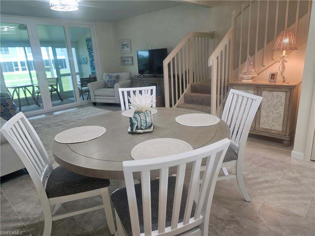 Image 3: Dining room featuring stairway and stone tile flooring