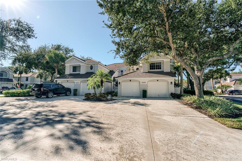 Image 2: Coach Home featuring driveway, stucco siding, an attached garage, and a tiled roof