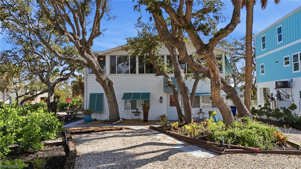 Image 3: View of front of home with a sunroom - Virtually Edited Image