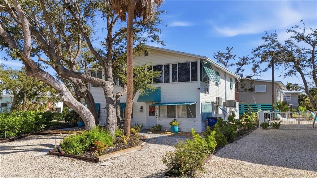 Image 4: View of front of home featuring a sunroom - Virtually Edited Image