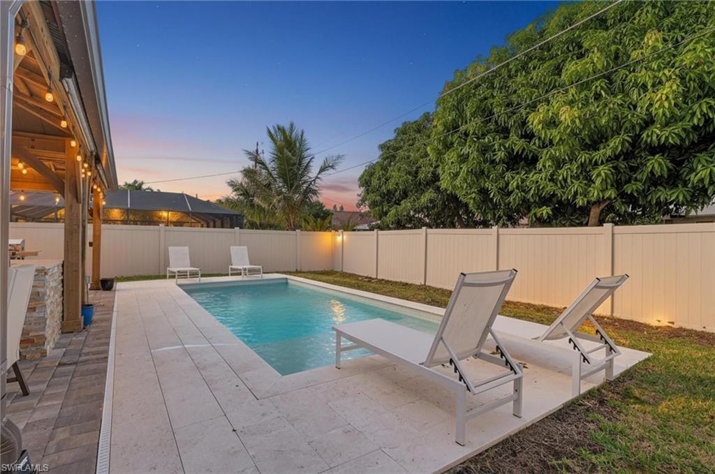 Image 2: View of swimming pool featuring a patio and a fenced backyard