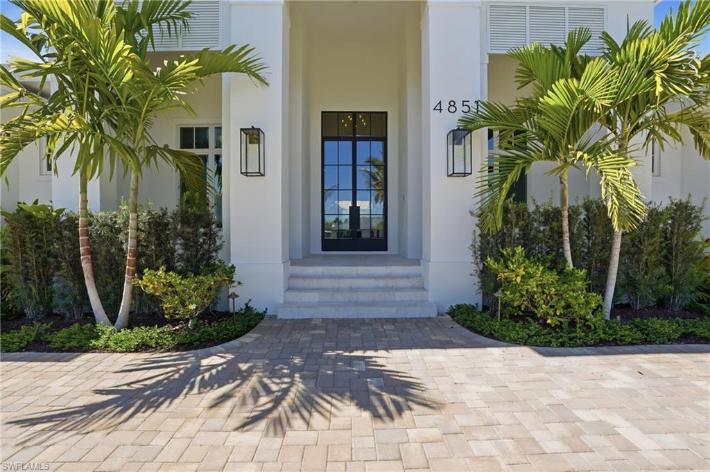 Image 2: Doorway to property with stucco siding and french doors