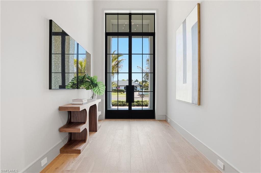 Image 4: Doorway with hardwood / wood-style flooring, french doors, and a high ceiling