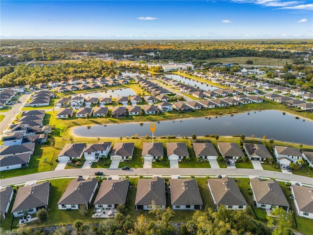 Image 2: Aerial overview of property's location featuring nearby suburban area and a nearby body of water