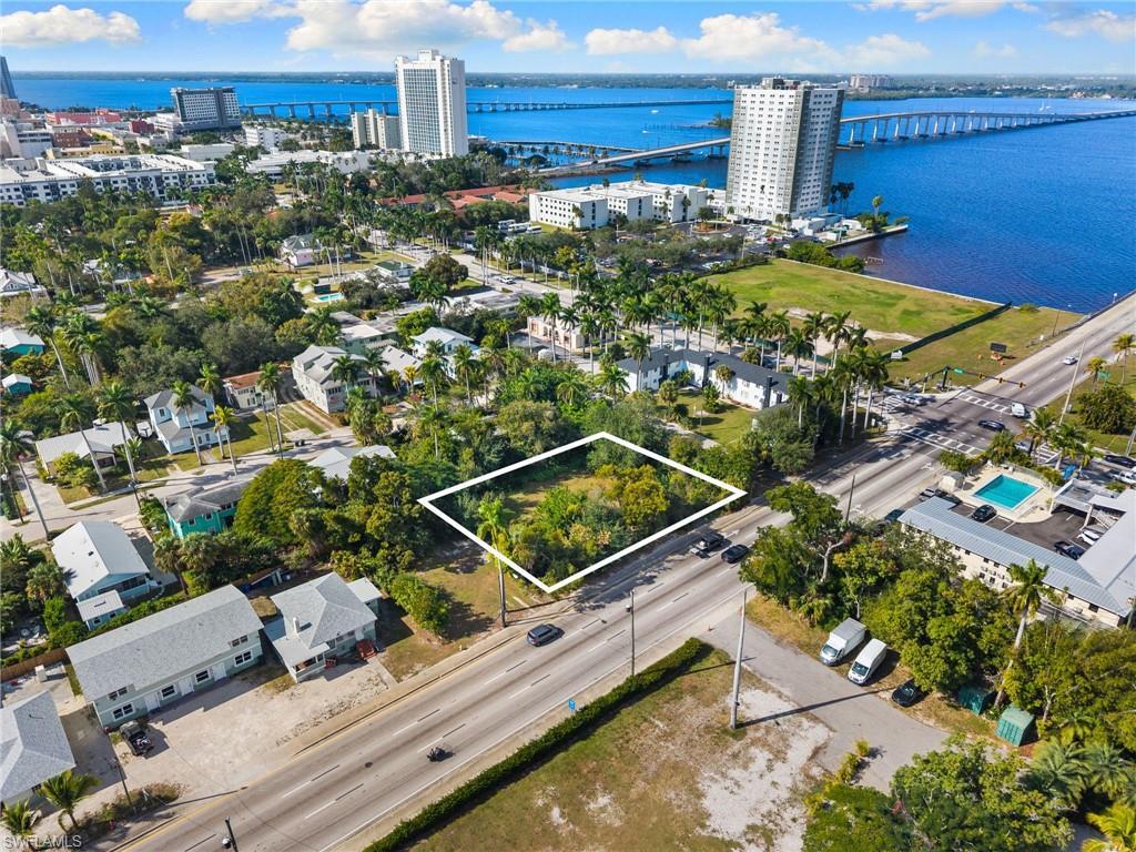 Image 3: View of urban area with a notable bridge, property parcel outlined, and a nearby body of water