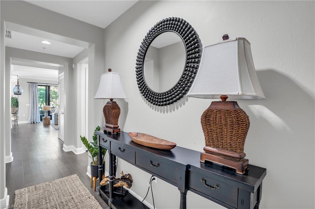 Image 2: Corridor featuring dark wood finished floors and baseboards