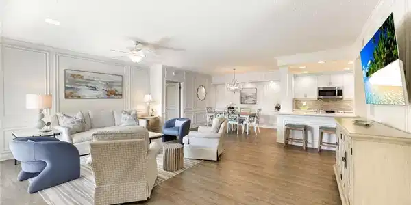 Image 4: Living area with ceiling fan, a decorative wall, crown molding, a textured ceiling, and light wood-style floors