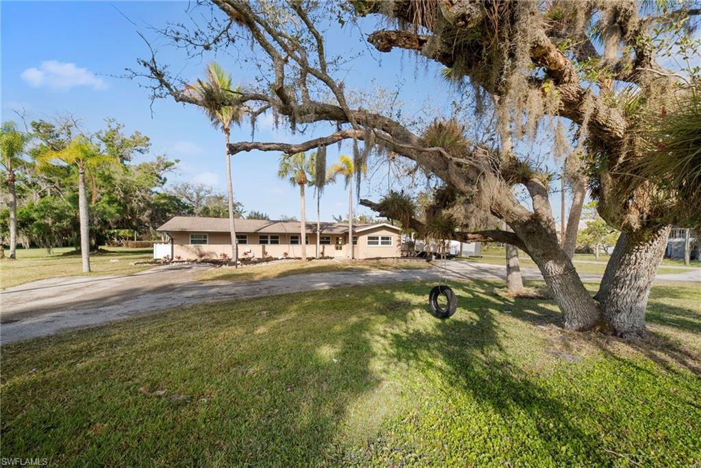 Image 2: Ranch-style house with a front yard