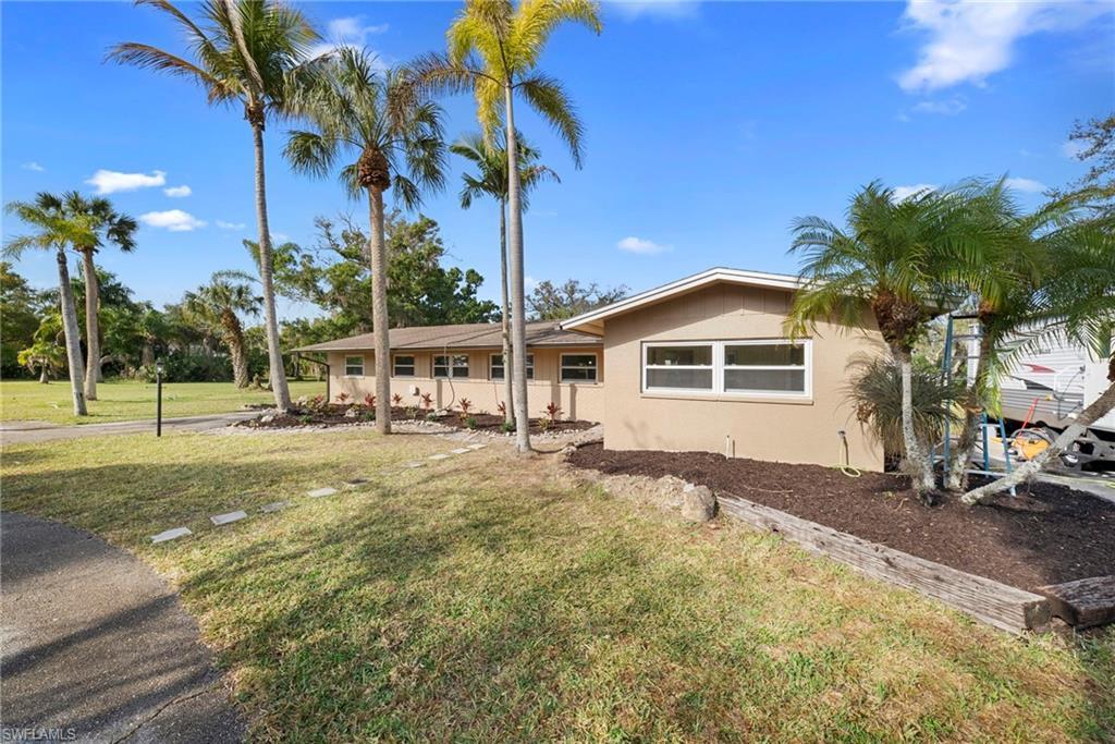 Image 4: Ranch-style home featuring a front yard and stucco siding
