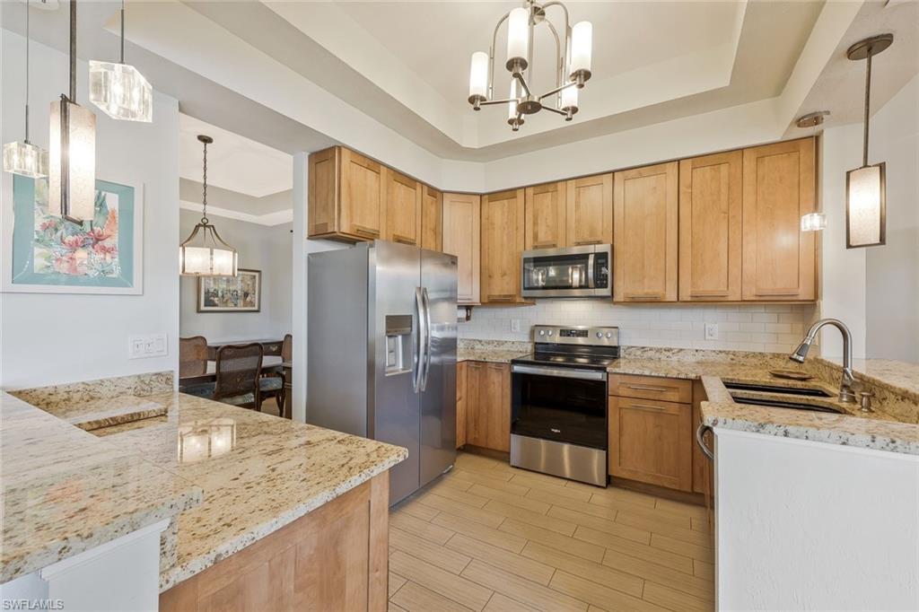 Image 3: Kitchen has been tastefully updated with TONS of cabinet space.