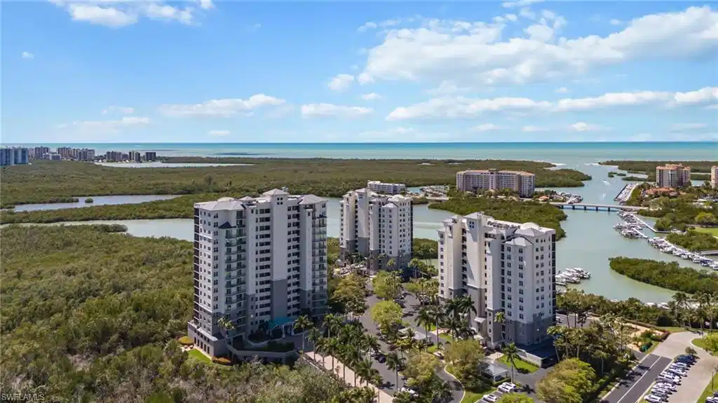 Image 1: View of urban area featuring apartment complex and a nearby body of water