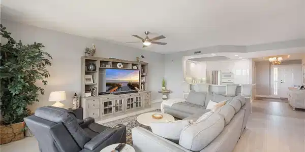 Image 4: Living area with ceiling fan, hanging lights, and light wood finished floors