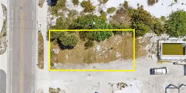Image 3: Aerial view of property and surrounding area with property parcel outlinedchange color of water into natural dark blue canal water