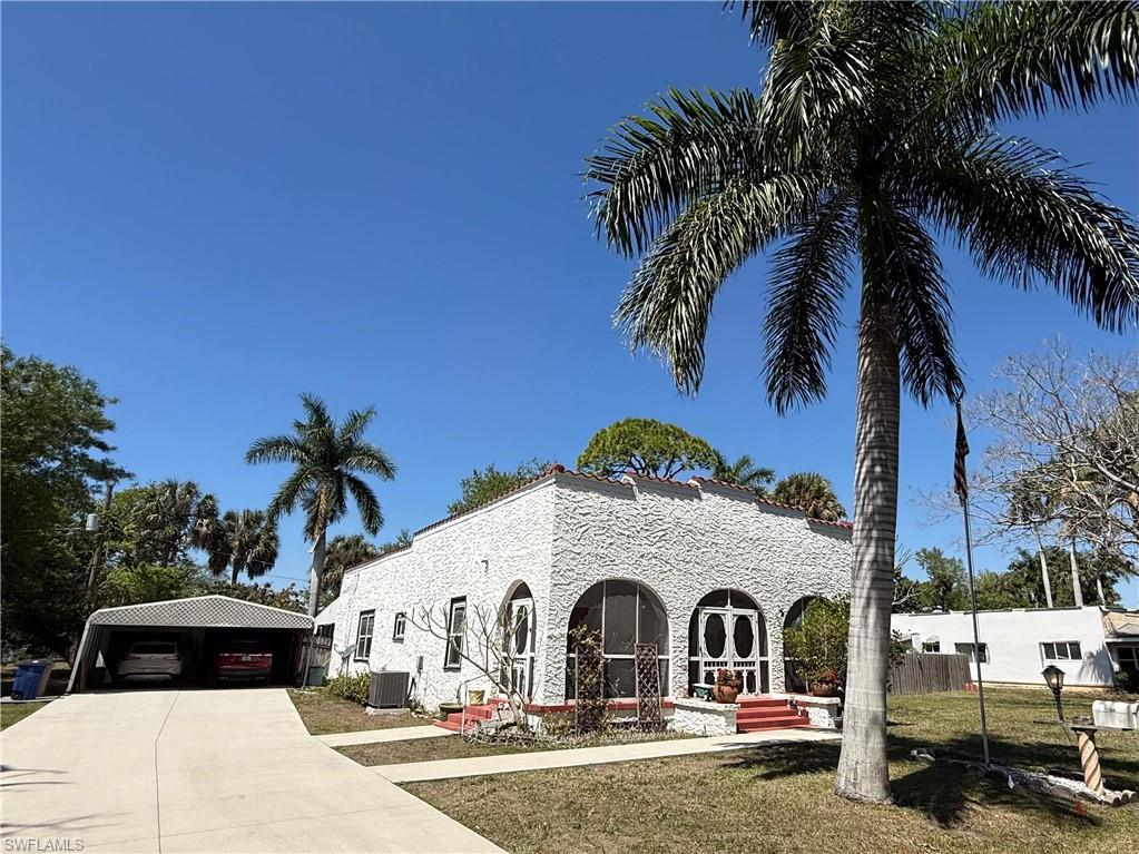 Image 1: Long drive with covered parking. Charming curb appeal.