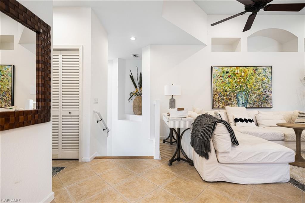 Image 3: Bedroom featuring light tile patterned flooring, ceiling fan, and a closet