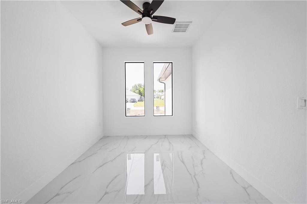 Image 4: Room featuring white walls and large-format porcelain tile flooring