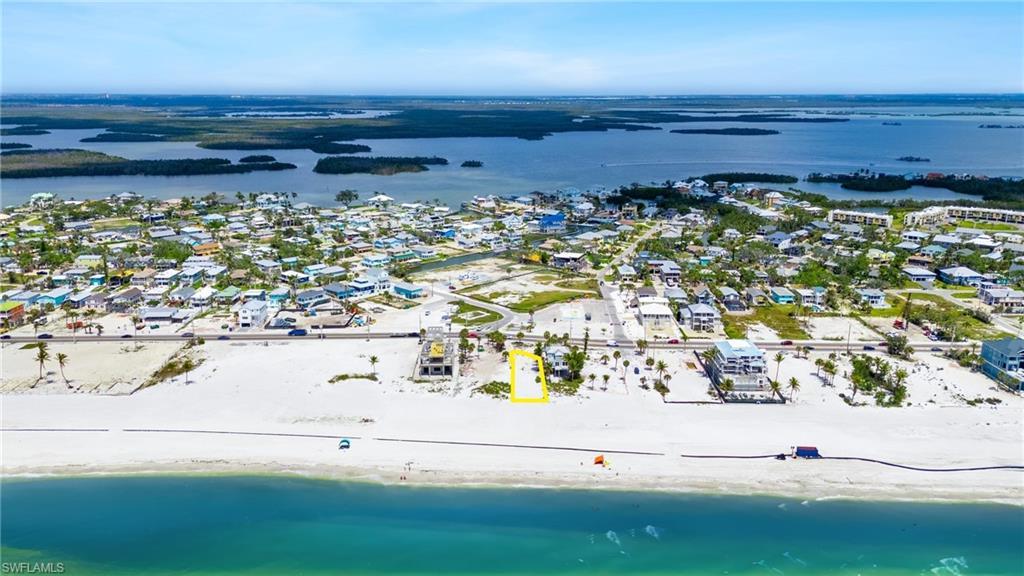 Image 4: Drone / aerial view with a water view, a beach view, and a residential view  - Virtually Edited Image