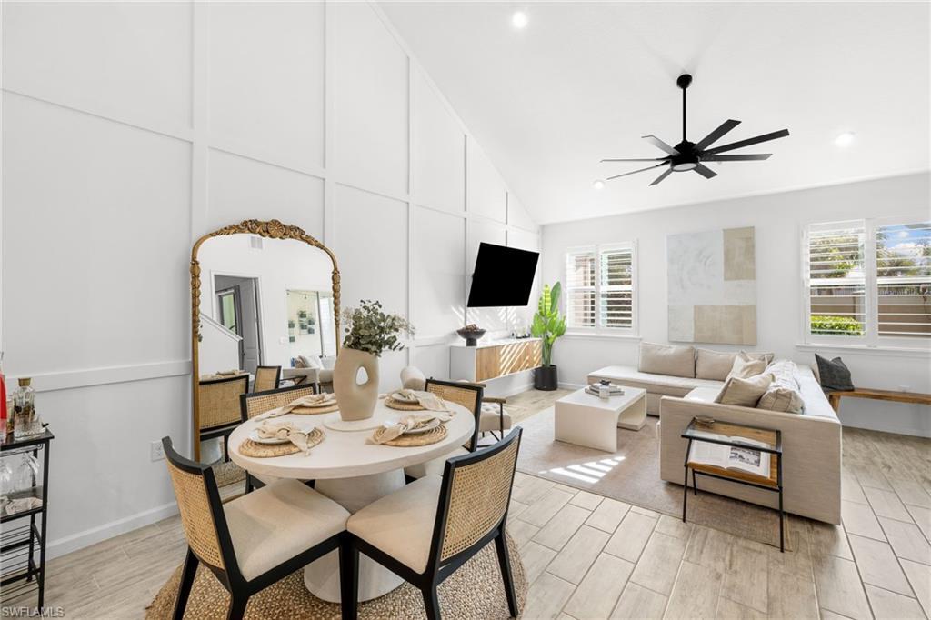 Image 2: Open-concept living space with a vaulted ceiling, recessed lighting, and a modern ceiling fan