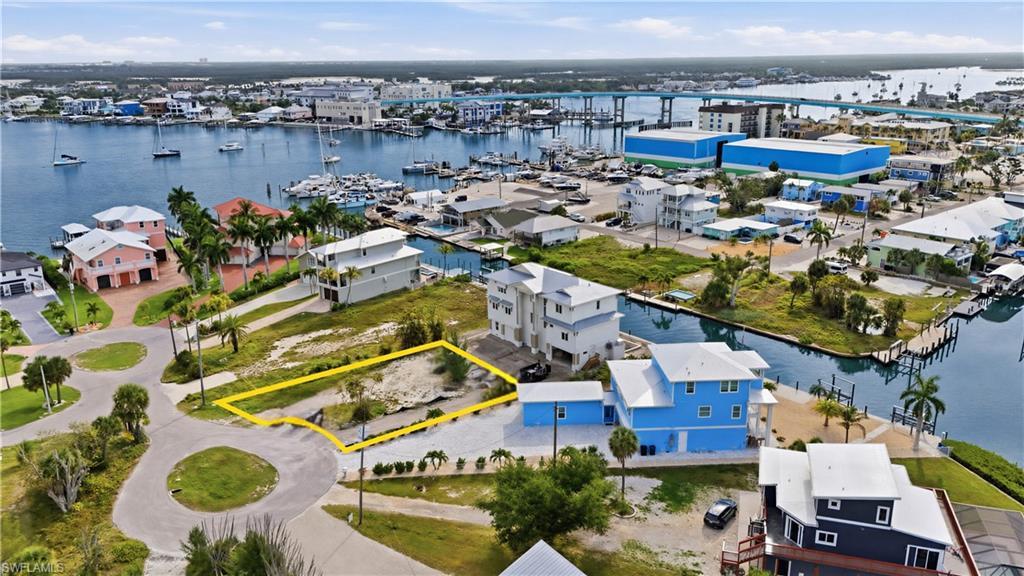 Image 3: Aerial view of lot surrounded by bay- virtually enhanced