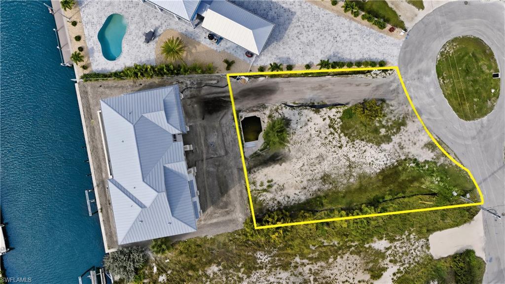 Image 4: Aerial view of lot surrounded by bay- virtually enhanced