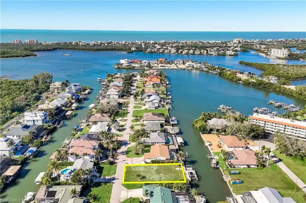 Image 1: Waterfront parcel featuring direct canal access to expansive bay waters - Virtually Edited Image