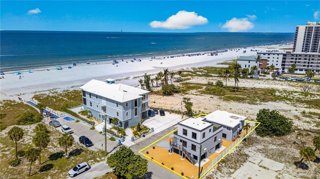 Image 2: Gulfview properties Two modern multi-story structures with flat roofs, featuring exterior staircases and elevated outdoor decking