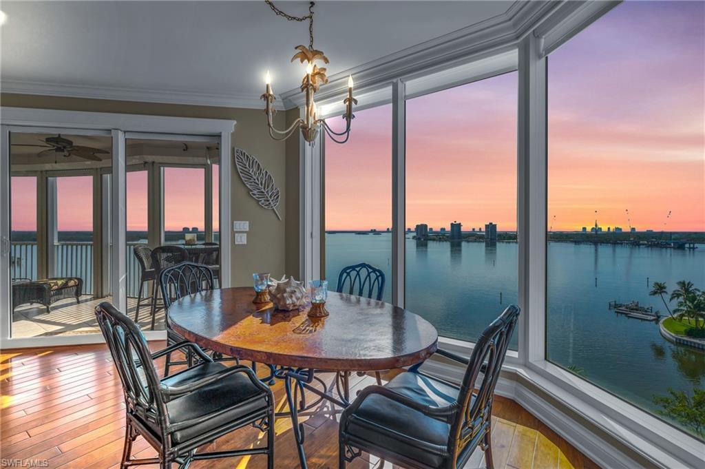 Image 4: Dining room featuring crown molding, a water view, hardwood / wood-style floors, and a wealth of natural light