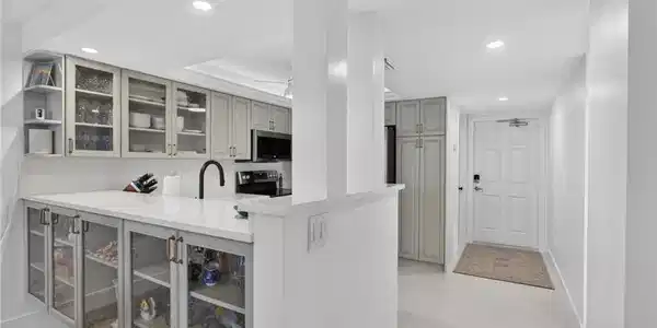 Image 3: Exquisite Remodel. Additional glass cabinetry under the counter.
