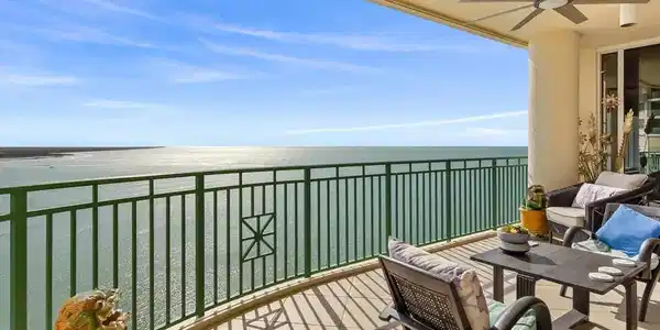 Image 2: Balcony with ceiling fan, a water view, and an outdoor living space