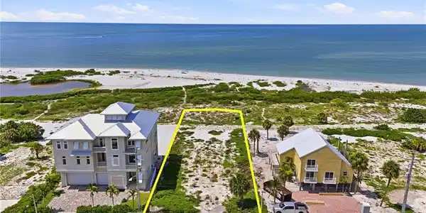 Image 3: Expansive lot featuring direct beach proximity, clear ocean frontage, and natural coastal vegetation - Virtually Edited Image