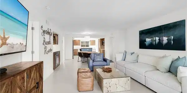Image 4: Open concept living area featuring light-toned flooring and recessed ceiling lighting