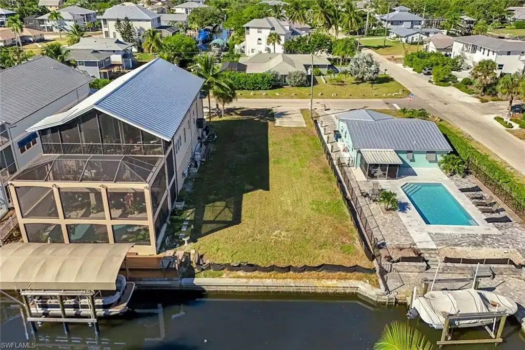 Image 1: Aerial perspective of suburban area with a nearby body of water