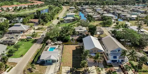 Image 4: Aerial view of residential area featuring a large body of water