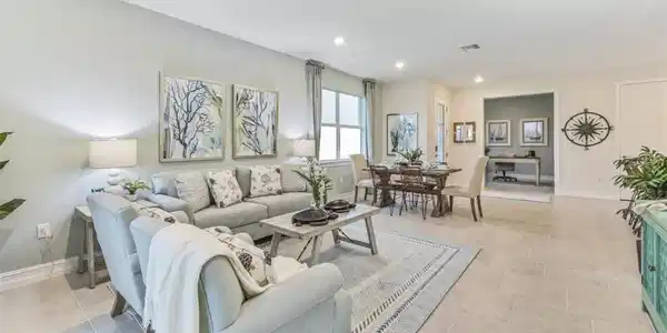 Image 3: Open-concept living area with large format tile flooring, recessed lighting, and a dedicated dining space