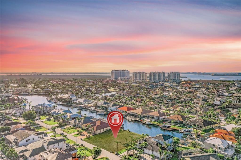 Image 3: View of property location featuring a nearby body of water and nearby suburban area