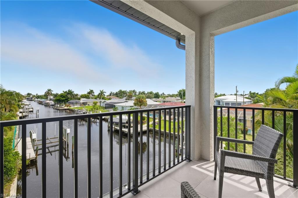 Image 3: Balcony featuring a water view and a residential view