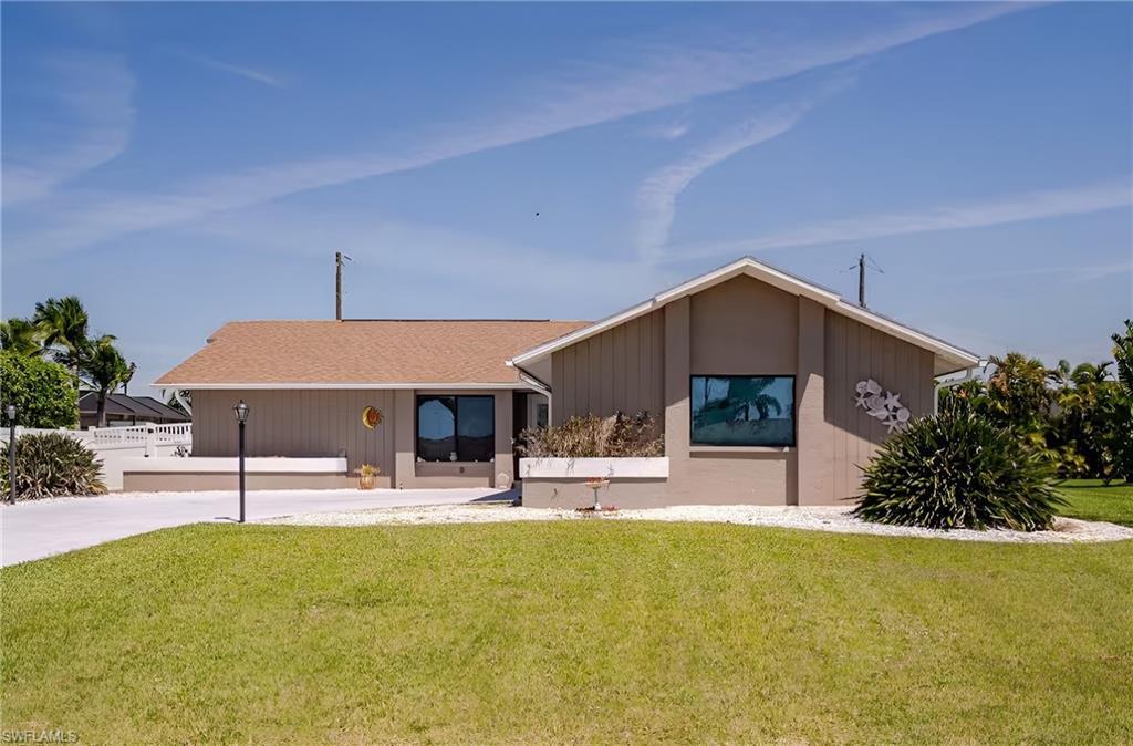 Image 1: View of front of property with a shingled roof