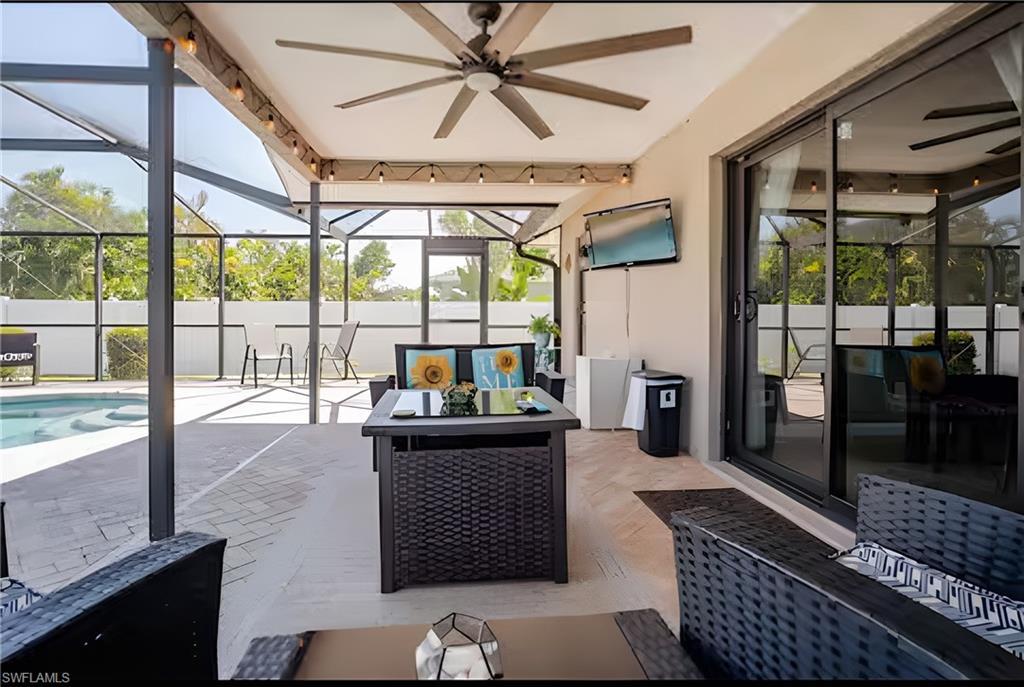 Image 4: Sunroom / solarium featuring a ceiling fan, a patio area, outdoor lounge area, and a swimming pool