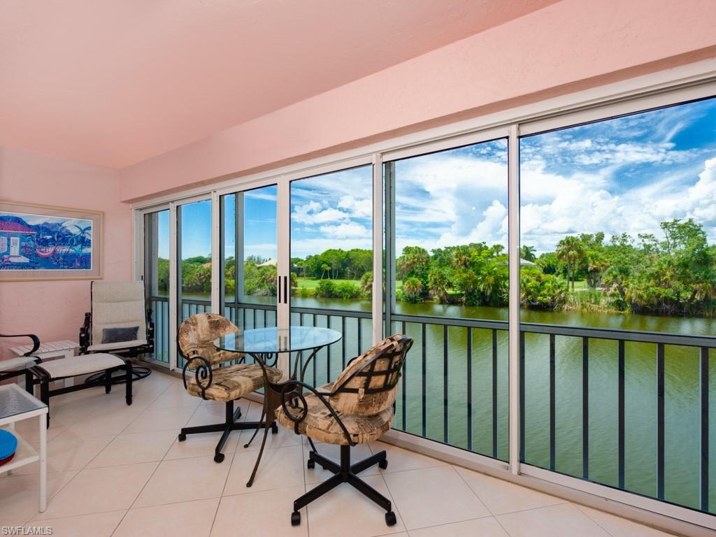 Image 4: Sunroom featuring a water view and view of wooded area