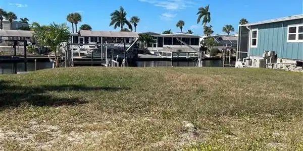 Image 4: View of grassy yard with a water view
