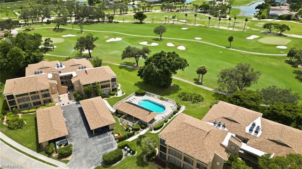 Image 2: Multi-story residential buildings with covered parking structures and an outdoor swimming pool, all situated alongside a golf course with water features