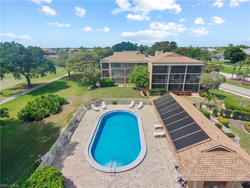 Image 3: Community pool featuring a patio area